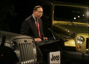 Gov. Bob Taft is surrounded by shiny new Jeeps. The state gave incentives to DaimlerChrysler and three automotive suppliers.
