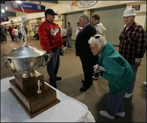 Oregon resident and season ticket holder Kathy McNeal gets an up-close look at the Governors  Cup during a
celebration at Fifth Third Field. The Mud Hens organization emphasized that the fans played a big
part in the club s second championship season in a
row.  It was justice that we finally got to win the championship here this year in front of you fans,  Larry
Parrish, the Mud Hens  manager, said. The Hens won last year s championship on the road.