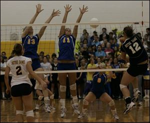 St. Ursula's Ashley Heyman (13) and Hannah Boggus (11) try to block a shot by Notre Dame's Jessica Batanian (12).