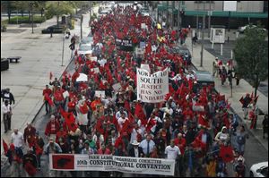 About 500 migrant workers who are delegates at the FLOC convention march from SeaGate Centre to the Lucas County Courthouse to rally for migrant and immigrant rights.