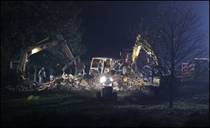 The Amish school in Nickel Mines, Pa., where a gunman shot 10 girls last week, killing five of them, is demolished by private contractors before dawn today.