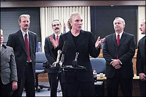 Julia Bates, Lucas County prosecutor, speaks as fellow prosecutors Kevin Dituch, left, Larry Kiroff, and Jeff Lingo listen after the verdict in the Noe case in the Lucas County courthouse.