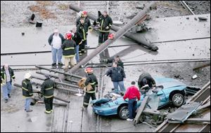 The top of one auto was crushed, injuring Bob Loe, the village s streets superintendent, who was the closest to the crossing.
