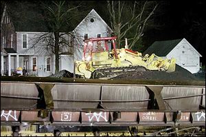 A bulldozer pushes coal around during the clean-up last night.