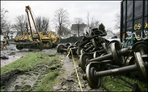 Wheels from railcars that derailed are strewn around the
accident scene as crews remove debris. Both of the mainline CSX tracks involved in the incident reopened yesterday.