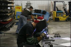 Jason Baugher welds steel in the assembly room. Owner
Kenneth Martin started Projects Designed in his home.