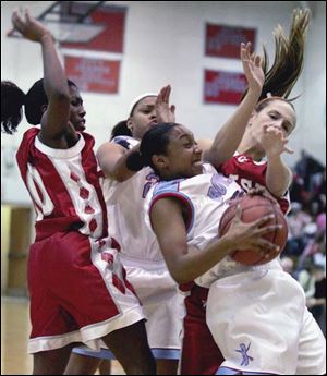 Bowsher's Ciara Palmer snags a rebound in front of Central Catholic's Sharise Calhoun, left, last night in City League action.