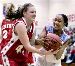 Central Catholic's Valerie Gang, left, and Bowsher's Ciara Palmer show their determination in fighting for the ball.