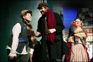 From left, Tiny Tim (Mary Wagner), Bob Cratchit (Seth Shaffer), and Mrs. Bob Cratchit (Kim Yost) perform during a dress rehearsal of Mrs. Bob Cratchit's Wild Christmas Binge.