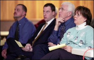 Township Trustee Carol Contrada, right, listens to a resident's question at the meeting. 