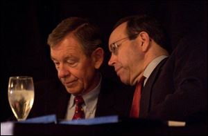 Former Ohio Gov. George Voinovich and Gov. Bob Taft
chat at a meeting in 2001. 