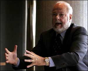 Jerry Arkebauer presides over a July, 2005, port authority hearing. He is retiring after 18 years with the development agency.