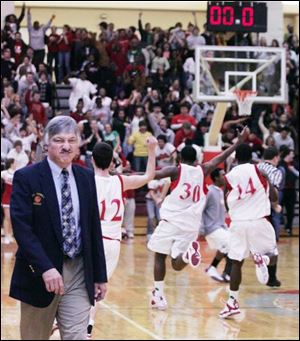 St. John's coach Ed Heintschel walks off the floor as Central snapped a 12-game winless streak against the Titans.