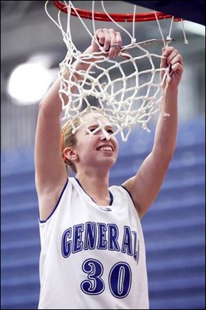 Anthony Wayne's Ashley Bromley takes her turn at cutting down the net after the Generals won their first girls basketball title.