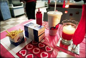 An array of fries, sliders, and diet Coke is complemented by candlelight and flowers. This year was the second year in which White Castle has offered the Valentine's Day special.
