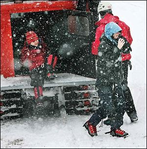 Two of three climbers stranded since Sunday on Mount Hood arrive at White River snow park near Government Camp, Ore.