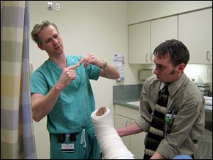 Chad Niemann, a physician's assistant at Toledo Hospital, wraps my leg in what they called a 