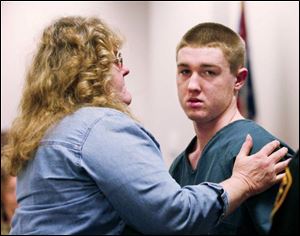 Diane Jobe comforts her son, Robert Jobe, after his appearance in juvenile court. The teen faces a hearing next month in the shooting death of a Toledo detective.