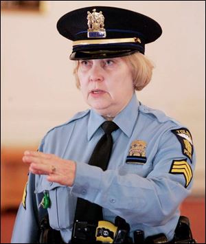 Toledo Police Sgt. Karen Martensen, another honor guard
member, practices for a day she knows will be emotional for her colleagues and the community.