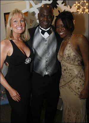 Toledo Fire Chief Michael Bell with Karen Jarosz, left, and his niece, Shayla Bell, at the Red Cross benefit.