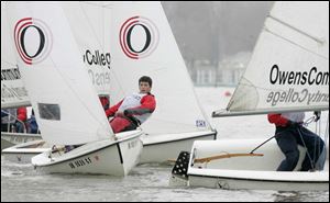 Three skippers from Owens Community College have their sailboats in tight quarters as they race against Michigan State. 