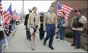 REG marine31p  03/31/07 The Blade/Dave Caption: Lance Corporal Evan E. Miller and his girlfriend Jennifer Constien, left, walk down a sidewalk lined by members of the Legion Riders, as he arrives  at a party in his honor at the VFW in downtown Defiance on Saturday, March 31, 2007.  Summary: Defiance Mayor Bob Armstrong is declaring March 31 to be Lance Corporal Evan E. Miller Day in Defiance. Evan, who is a Marine reservist, was seriously injured in Iraq.