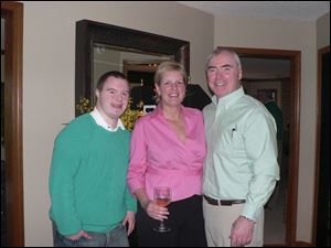 Mike Stanford, left, and his parents, Linda and Steve Stanford, gave their annual Margaritas and the Masters party at their home overlooking the Belmont Country Club golf course.