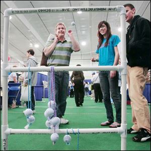 Jeff Neuman of Sylvania plays ladder golf with a few helpful hints from Samantha Jerabek, middle, and Austin Hendrix during the recent Showcase Sylvania Expo at Tam-O-Shanter.