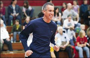 Lee Conklin reacts to a shot made by a teammate during a charity basketball game in March.