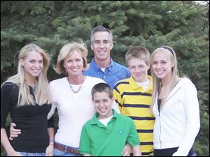 Lee Conklin with daughter Courtney, left, his wife, Lisa, sons Michael and Jake, and daughter Kelsey.