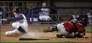 The Mud Hens' Mike Hessman scores after a suicide squeeze bunt from Dane Sardinha in the seventh inning. 