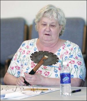 Norma Howard of Oregon closely examines a saw weapon that was on display during a session at the academy.