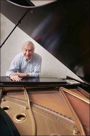 Sam Szor at home with his grand piano. Mr. Szor is retiring after 39 years as music director of First Congregational Church in the Old West End.