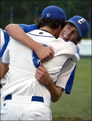 Elmwood shortstop Cory Stewart (facing) and pitcher Ryan Rothenbuhler celebrate the win.
