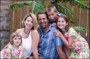 Sylvania native Carrie Brown-Wolf with husband, Dan, and children Olivia, 5, Tennyson, 7, and Ellie, 9.