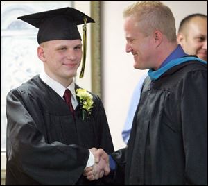 Northview High School officials, including principal Stewart Jesse, right, set up the special ceremony for James Ruane, 18, who is scheduled to graduate tomorrow afternoon in the Stranahan Theater.