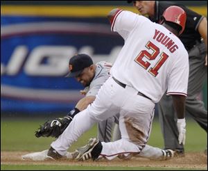 Former Tiger Dmitri Young beats the tag of Placido Polanco for a double in the second inning last night at RFK Stadium.