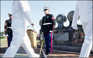 Marine Cpl. Craig Hampton, far right, stands at attention in front of the memorial.
<br>
(THE BLADE/AMY E. VOIGT)
<br>
<img src=http://www.toledoblade.com/graphics/icons/photo.gif> View View the <a href= 