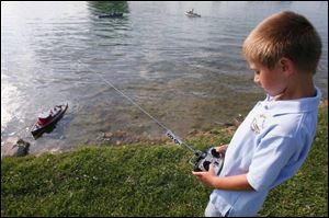 Ben Bostater, 7, concentrates on steering his boat.  