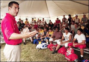 Ohio State assistant coach Luke Fickell talks to players who are preparing for Friday s regional all-star football game. 