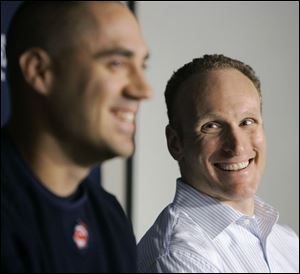 Indians GM Mark Shapiro, right, can smile even more now that slugger Travis Hafner is under contract through 2012.