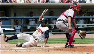 Henry Mateo slides home safely after scampering around from first base on a triple by Andres Torres in the fourth inning. The Hens were already in great shape, having scored five runs in the first inning. Toledo swept the series from Richmond.
