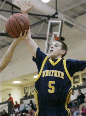 Whitmer s Ryne Smith drives to the basket against St. John s in a game last season. Smith,6-foot-3, 170 pounds, averaged 17.4 points as a junior for the 12-9 Panthers. 