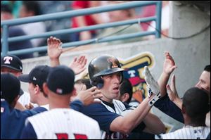 Mike Hessman is welcomed in the dugout after hitting his 30th home run this season. He leads the IL in RBIs with 95.