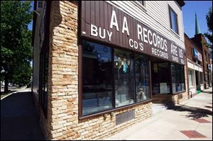 The facade of AA Records Are Us on Lagrange Street. The store, owned by Frank Lynn, has thousands of vinyl records for sale.
