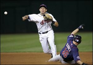 The Indians' Asdrubal Cabrera throws to first to get the Twins' Mike Redmond to complete a triple play. It was the Indians' first triple play in Cleveland since they did it in 1976.