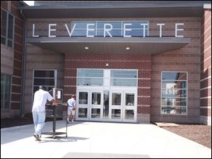 Teacher Ron Battle takes an audiovisual unit into the new Leverette Middle School. 