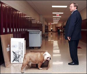 John Foley, superintendent of Toledo Public Schools, tours the new Byrnedale Middle School alongside Gracie, the school mascot. Educators, students, and parents seemed excited about the new schools. 