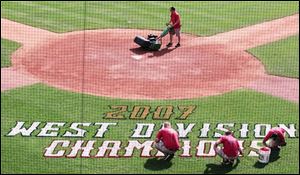 The grounds crew prepares Fifth Third Field for the Mud Hens  bid for a third straight Governors  Cup. The Hens clinched a spot in the International League playoffs with a win Sunday at Indianapolis and will play either Richmond or Durham in the fi rst round. As West Division champs, the Hens will host games three through five beginning Sept. 7.