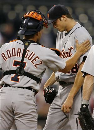 Catcher Ivan Rodriguez consoles departing Tigers pitcher Andrew Miller after he was stung with five earned runs in the first inning.